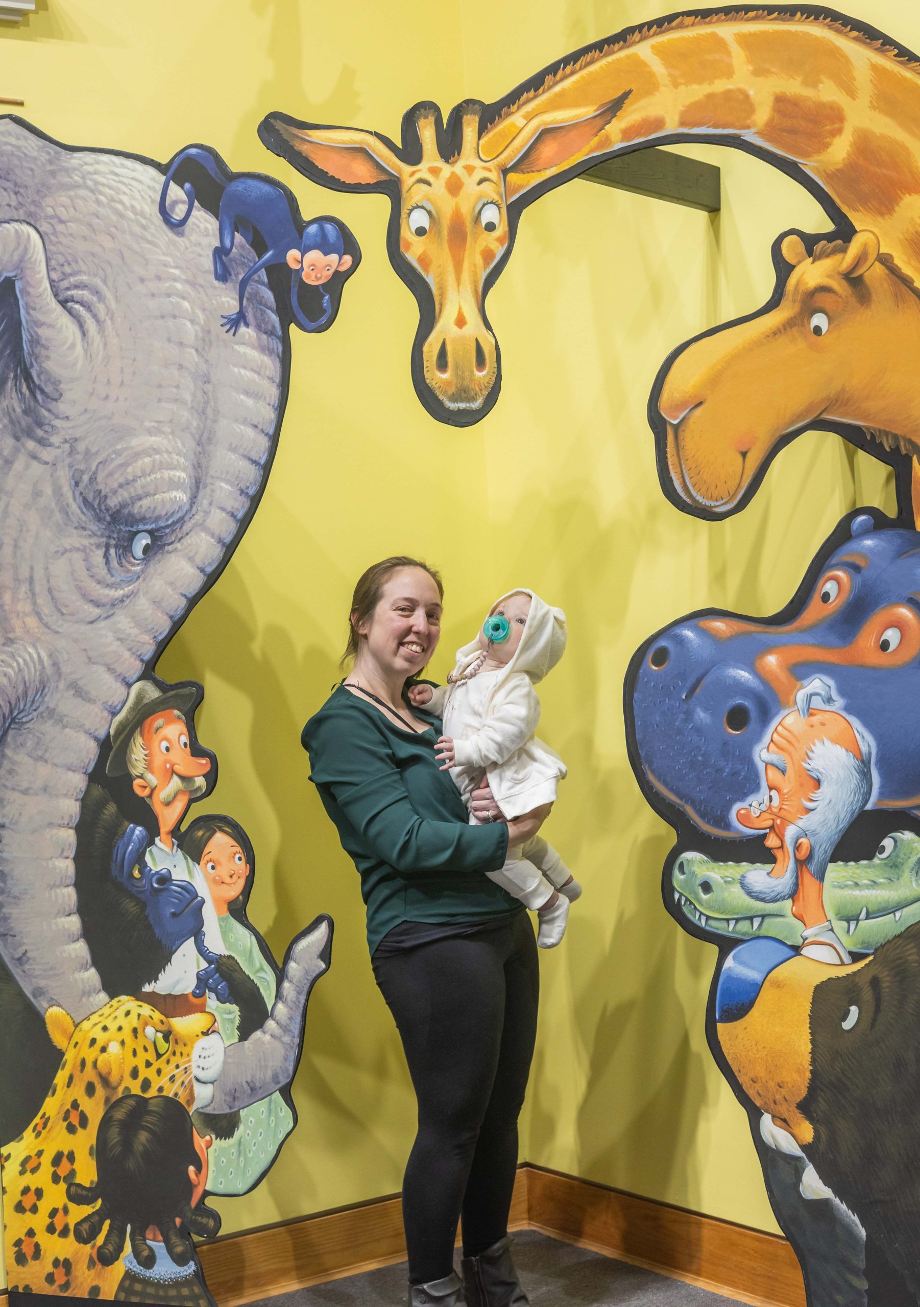 My daughter and granddaughter posing in front of the circus animals illustration